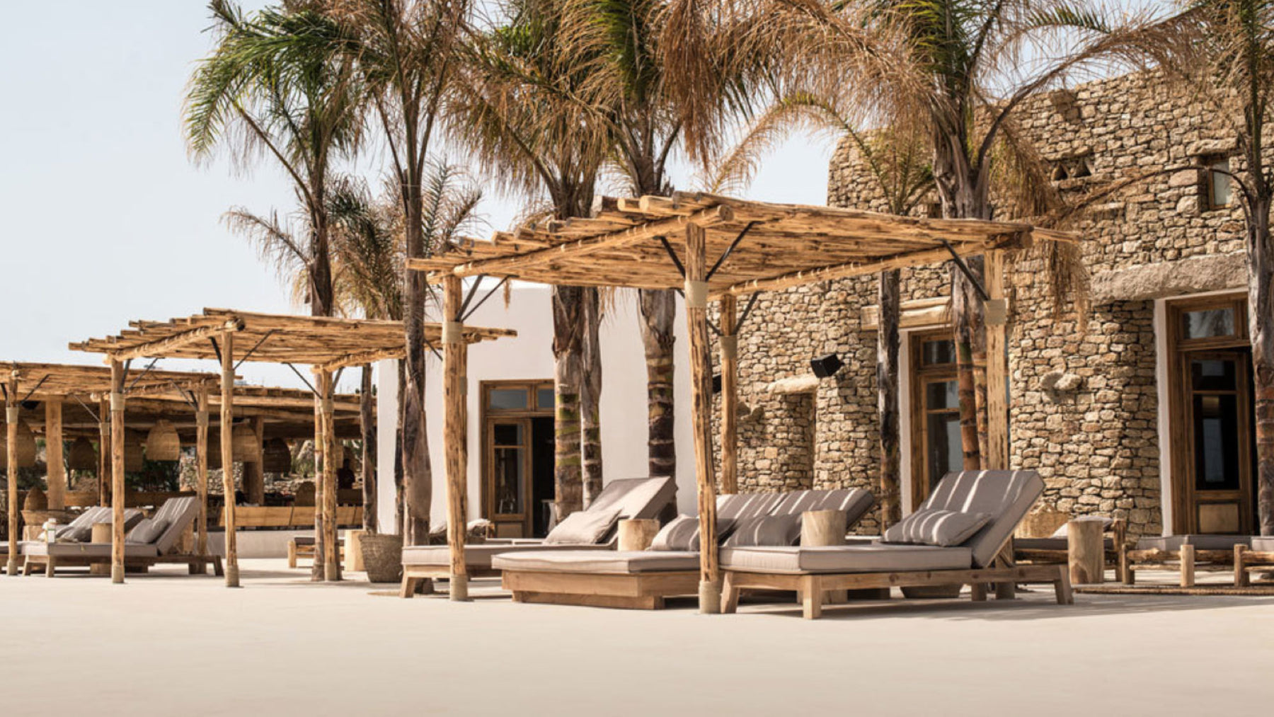 Mediterranean Beach Club outdoor furniture with chaise lounges.