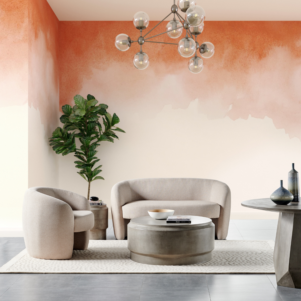 A grey round outdoor concrete coffee table set in a modern living room set up accompanied by light brown sofa and lounge chair