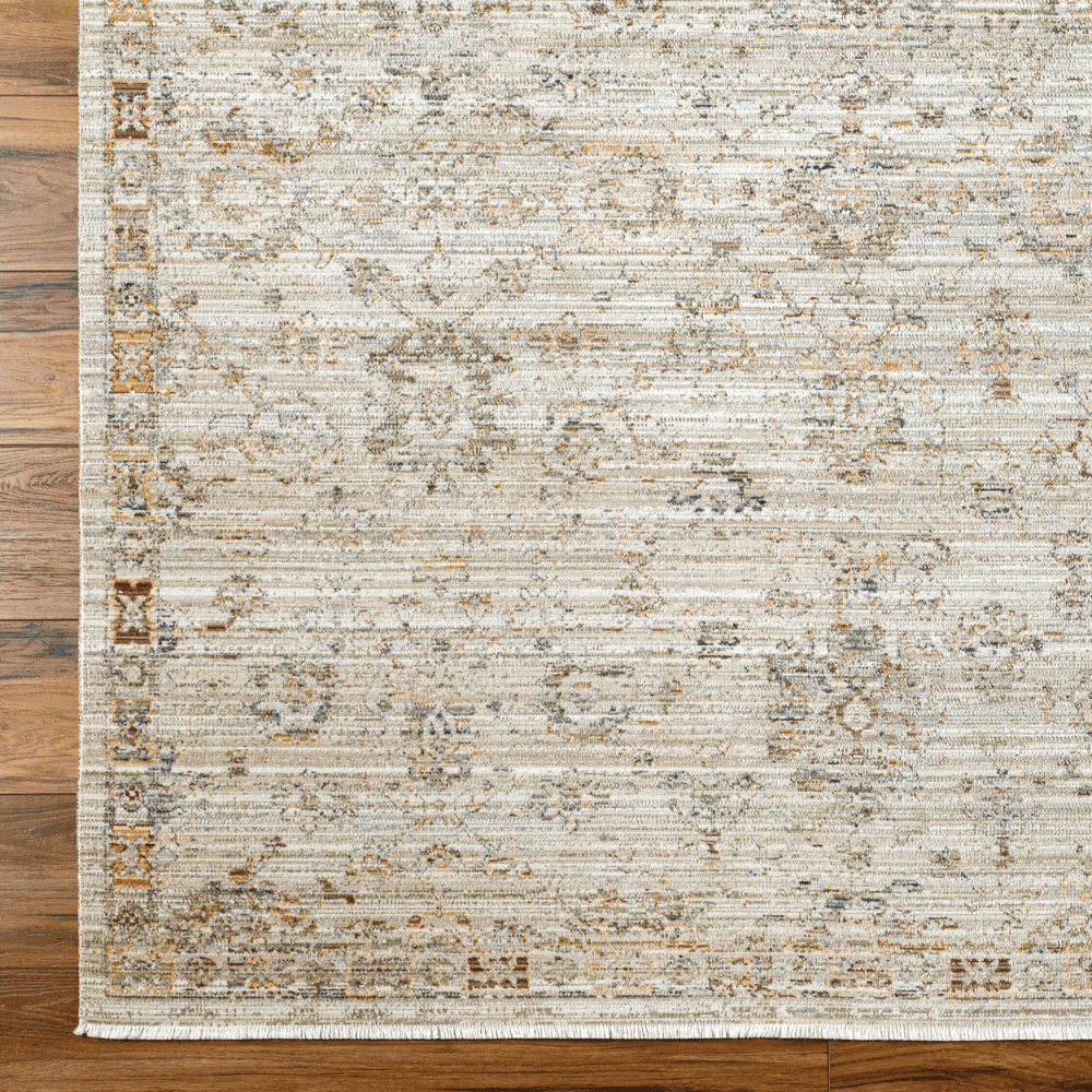 A Light brown machine woven outdoor rug with geometric pattern on a wooden  deck