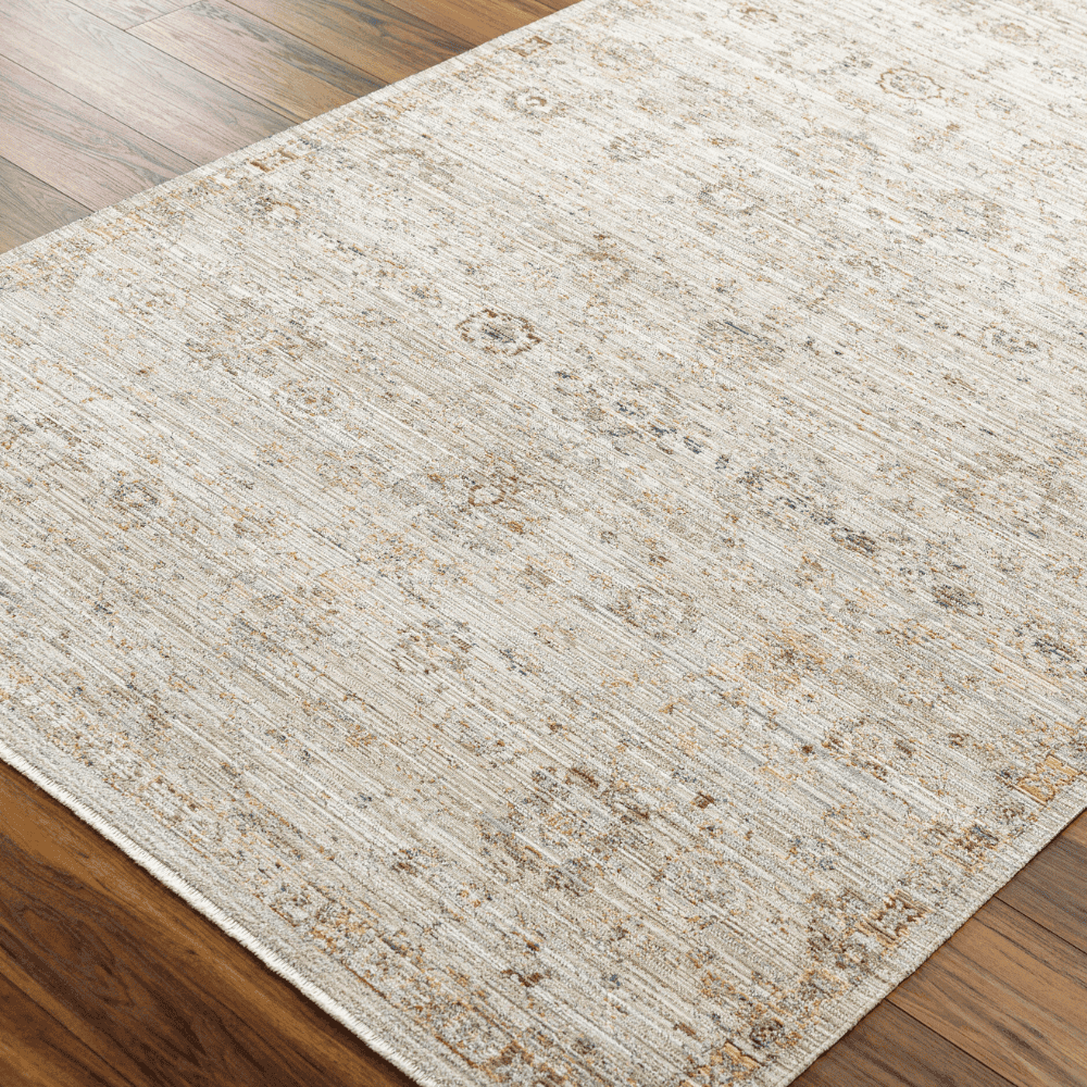 A Light brown machine woven outdoor rug with geometric pattern placed on a wooden floor