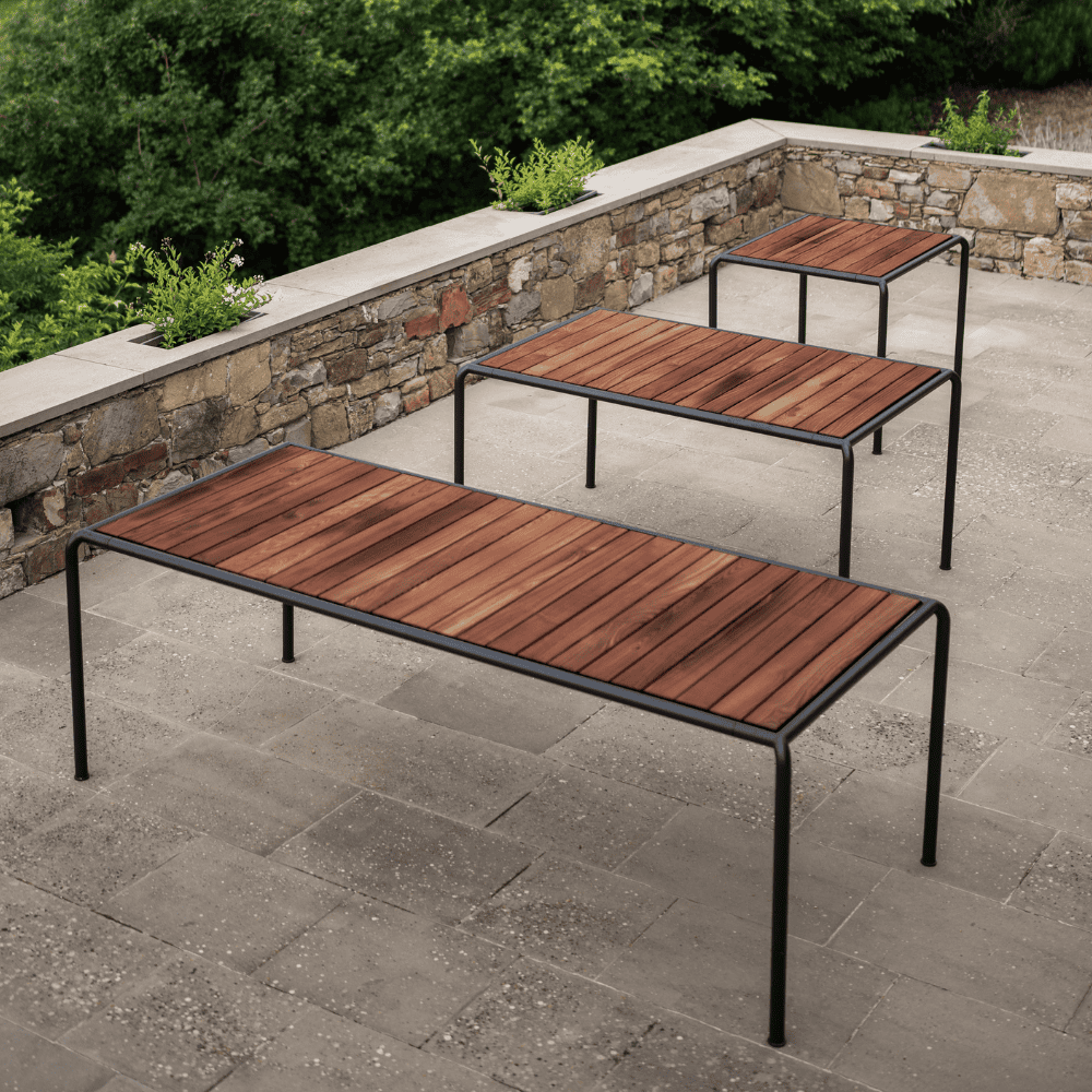 3 wooden outdoor dining tables with black metal frame in different sizes placed on patio