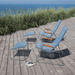 2 blue outdoor lounge chairs with bamboo armrest and 2 blue outdoor footrests with gray metal frame set on a wooden deck with tall grass