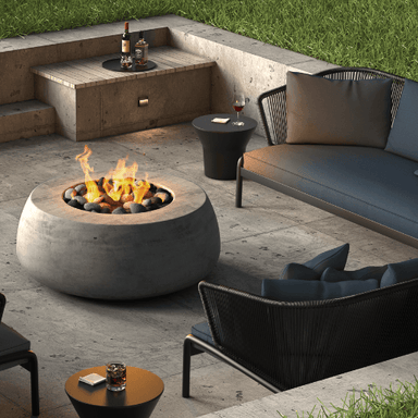 Dune Fire Bowl is a handcrafted outdoor concrete round fire bowl in grey with pebble stones by Boxhill