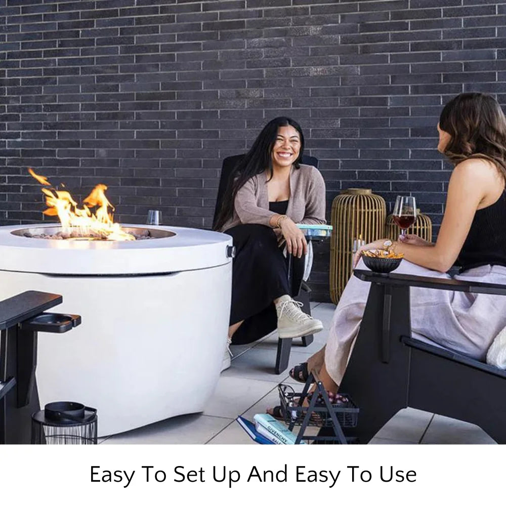  White round hidden propane tank fire pit placed in a patio with two women sit on a chair while having a chat