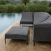 A poolside area with set of sofa and chairs covered by dark gray patio seat covers 