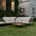 A lawn surface patio with square wooden outdoor coffee table with black aluminum frame and beige outdoor sectional sofa