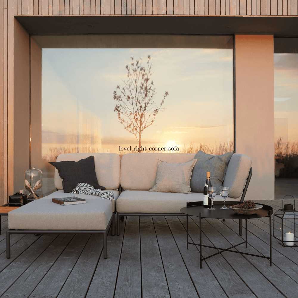 A beige right corner lounge sofa and beige lounge chair and ottoman set on a wooden deck patio in front of a glass wall