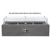 A gray outdoor concrete rectangular fire pit with wind guard