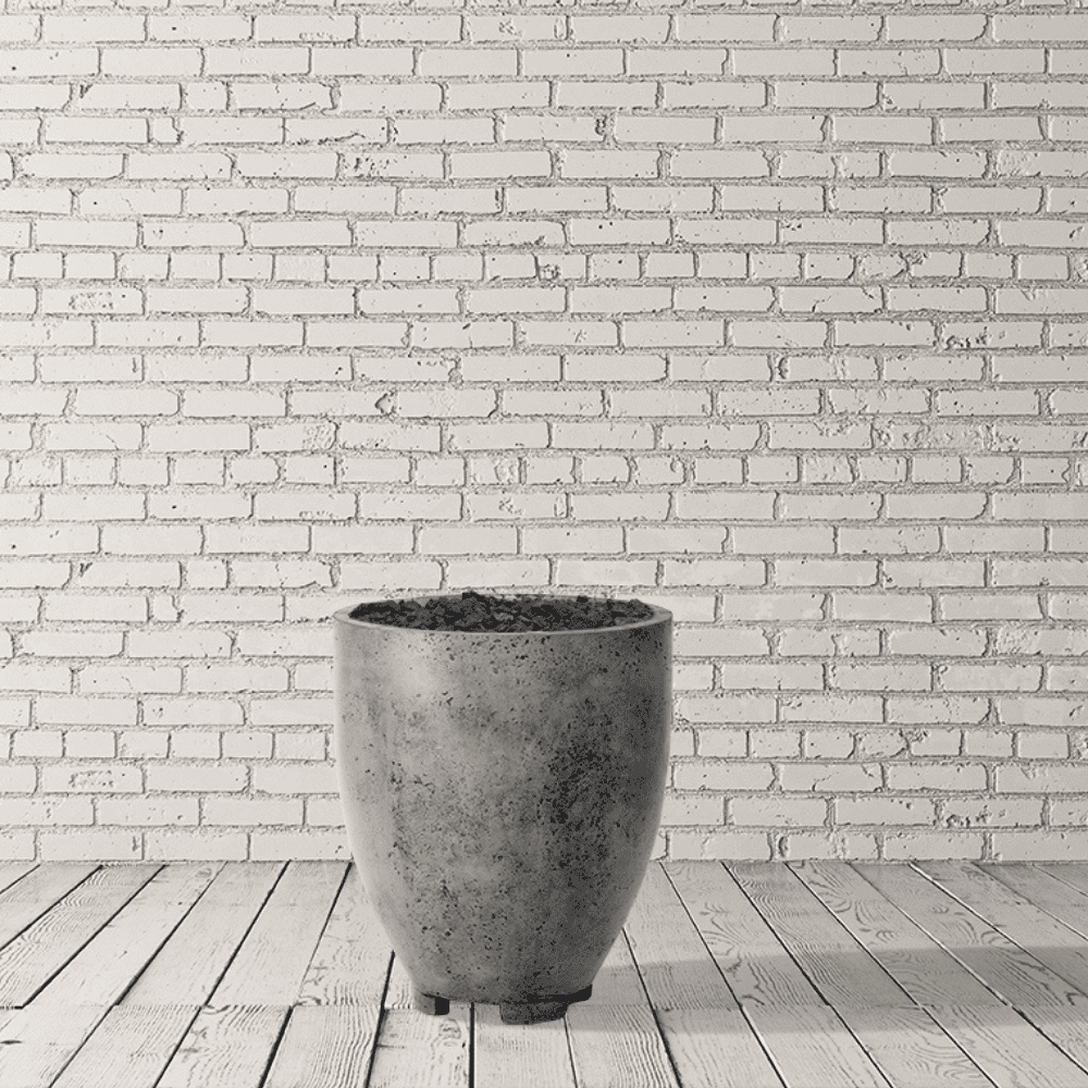 A grey outdoor concrete fire bowl placed on a wooden deck against white brick wall