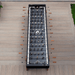 Top view of a black outdoor football table placed on a wooden deck