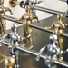 Close-up view of an outdoor football table with metallic football players on gold and silver-colored metal