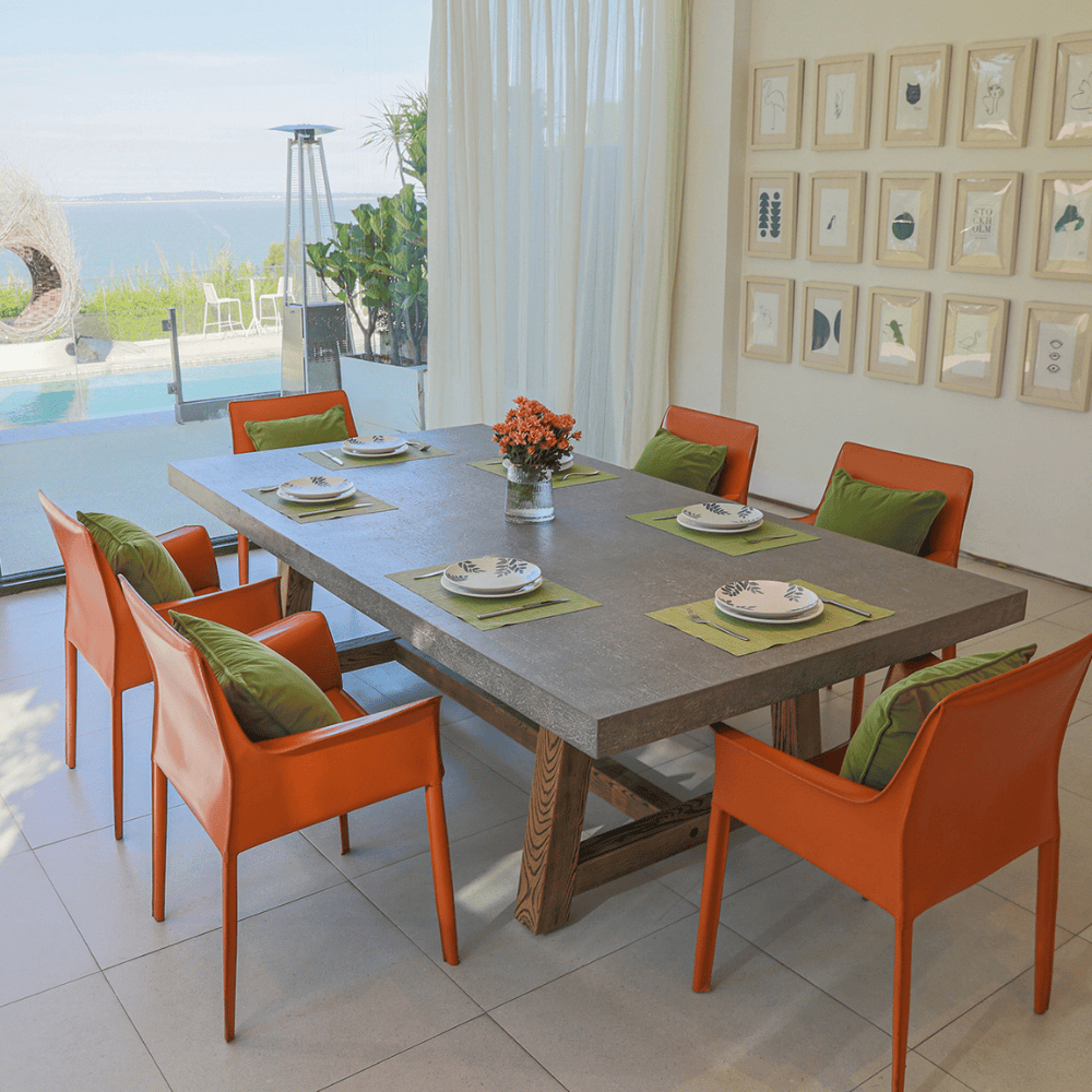 A concrete outdoor dining table featuring a sturdy wooden base, combining modern materials for a stylish look.