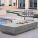 An outdoor area featuring a grey concrete outdoor rectangular fire pit placed beside the pool accompanied by a grey chair